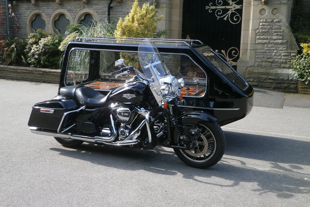 Harley Davidson motorcycle funeral hearse outside a church for a motorcycle funeral in Leicester